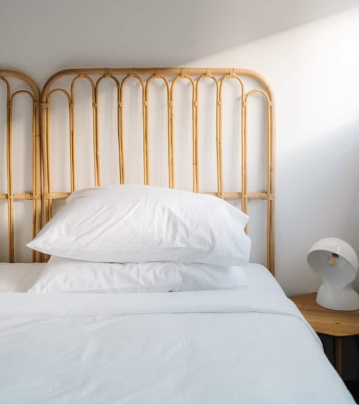 Empty bed with one pillow